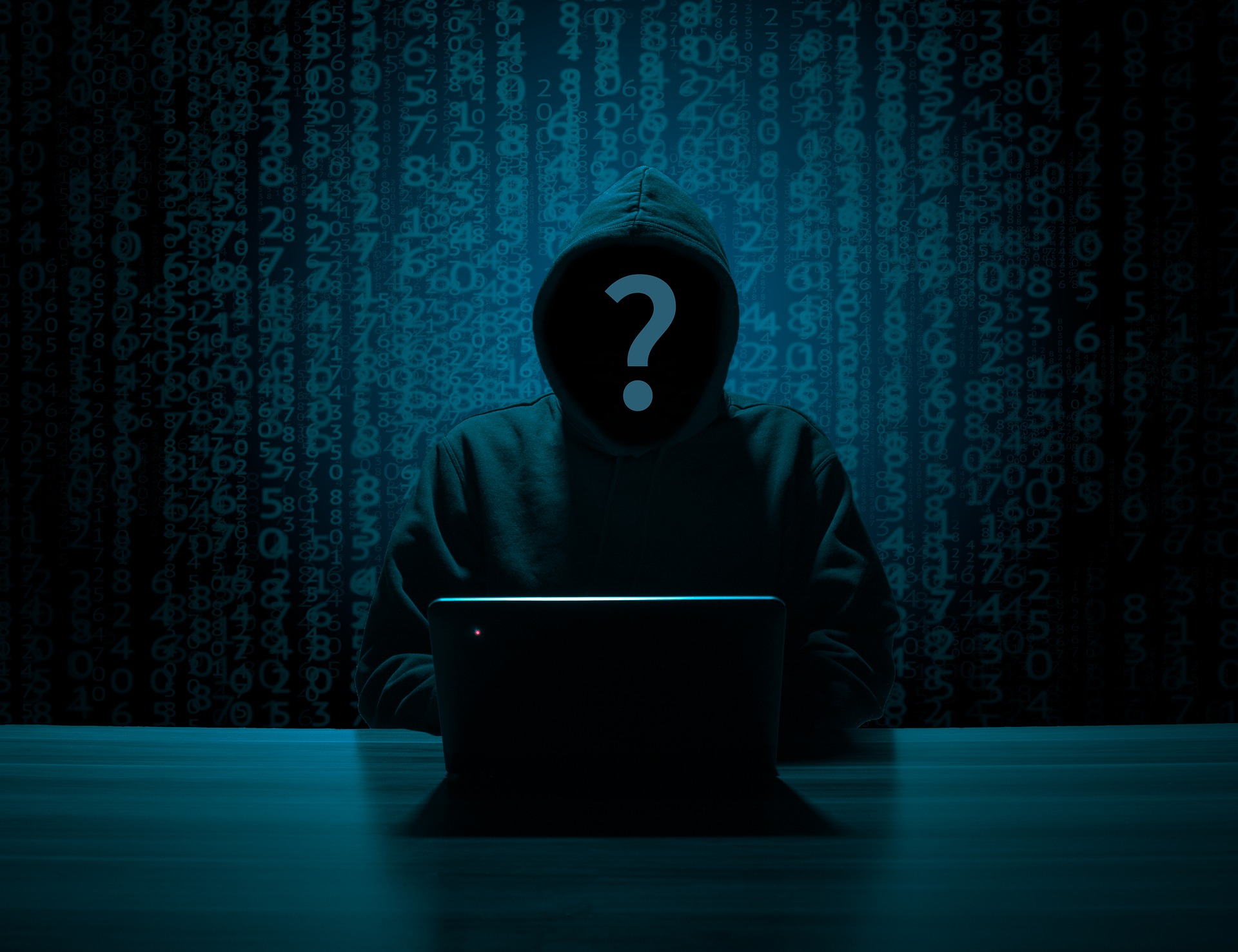 A picture of a malicious looking hacker in a hoodie with a question mark for a face.